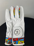 Women's white golf glove with colorful comic print on fingers and wrist, Skins Golf logo on wrist