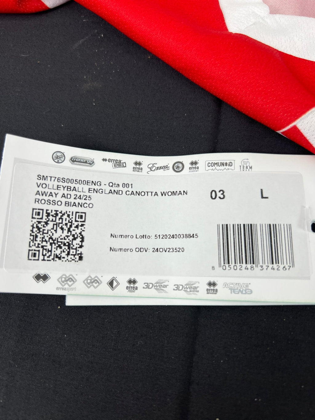 Close-up of product tag showing size L and product details for England volleyball vest