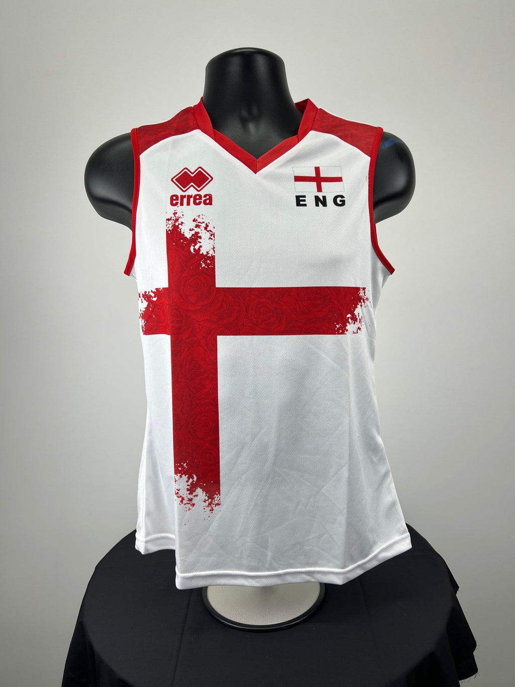 Front view of women's England volleyball vest featuring red St George's cross and embroidered flag on white fabric
