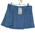 Nike blue sports skort with tag on green background