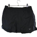 Black Nike sports shorts with white piping displayed on hanger