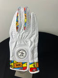 Women's white golf glove with colorful comic 'Boom!' motif on fingers and cuff, brand logo on strap