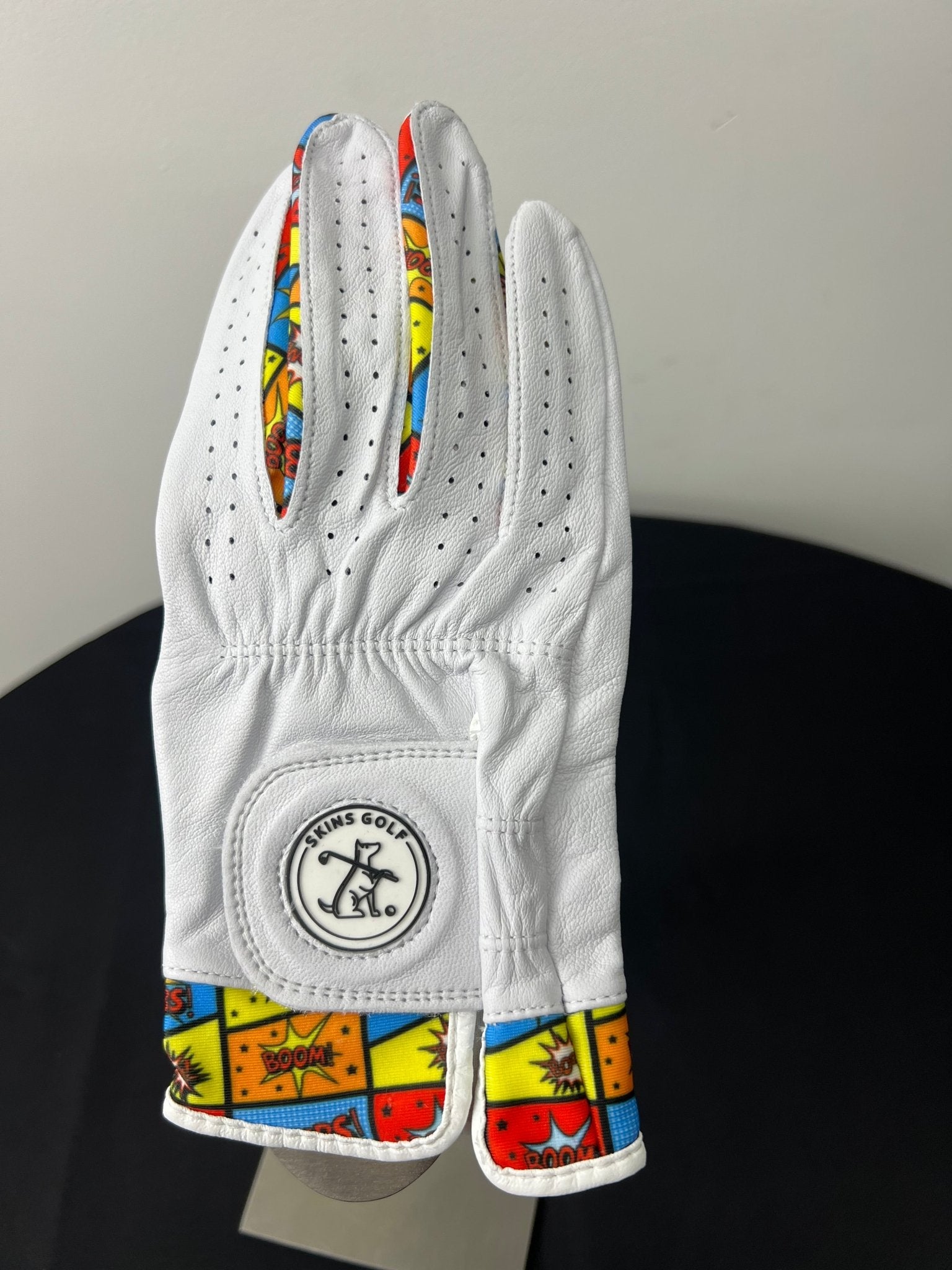 White women's golf glove with colorful comic pop art accents by Skins Golf