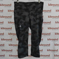 Under Armour black and grey patterned capri leggings displayed on hanger