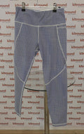 Front view of blue dot patterned Sweaty Betty Power 7/8 leggings hanging on a rack