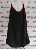 Front view of black Under Armour sports vest with coral straps displayed on a mannequin