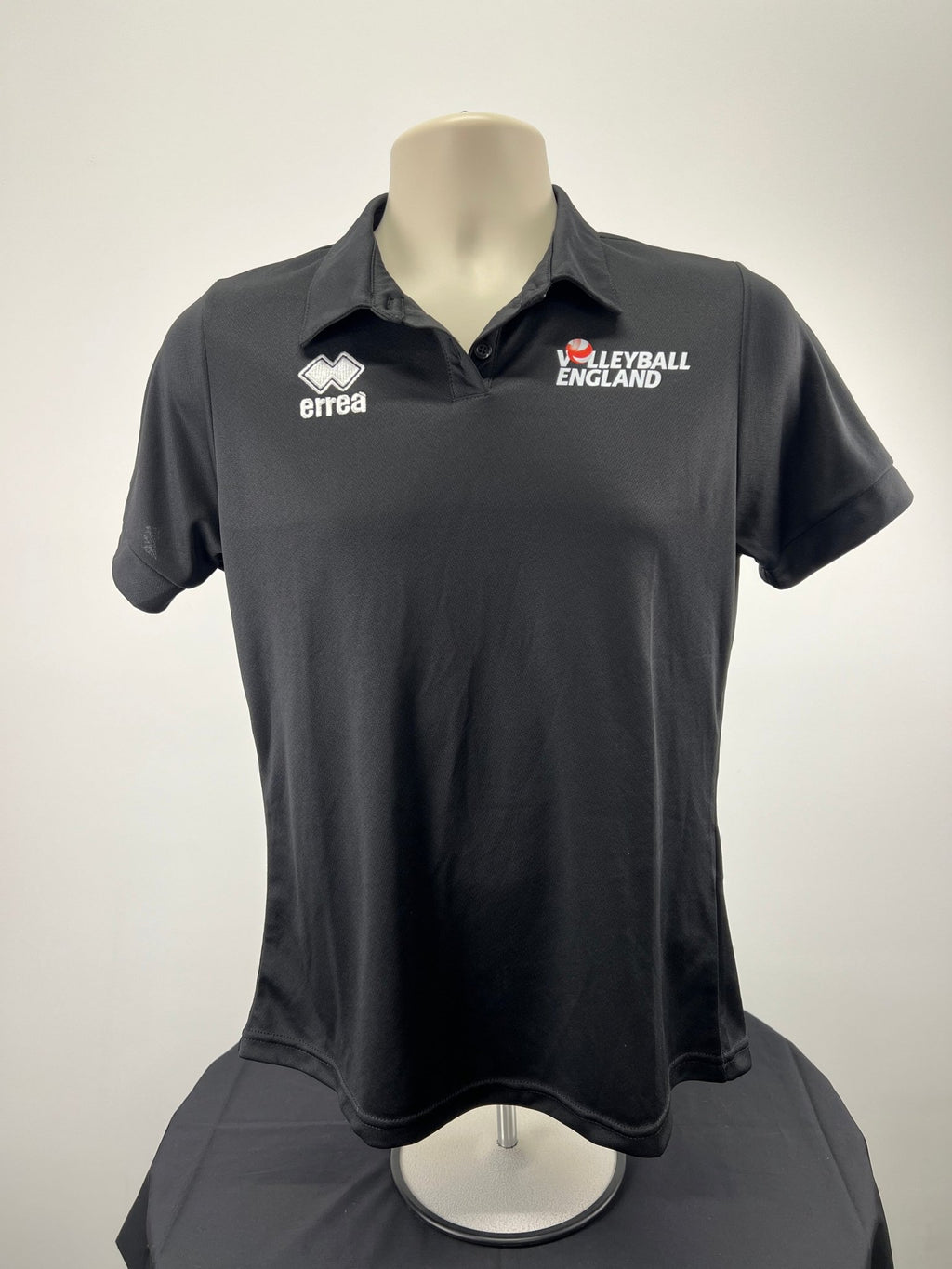 Front view of Women's Volleyball England black polo shirt, size medium