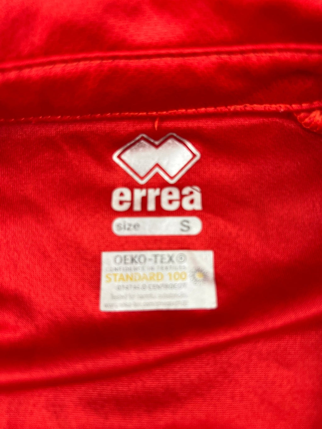 Close-up of Erreà size and OEKO-TEX label inside the shirt
