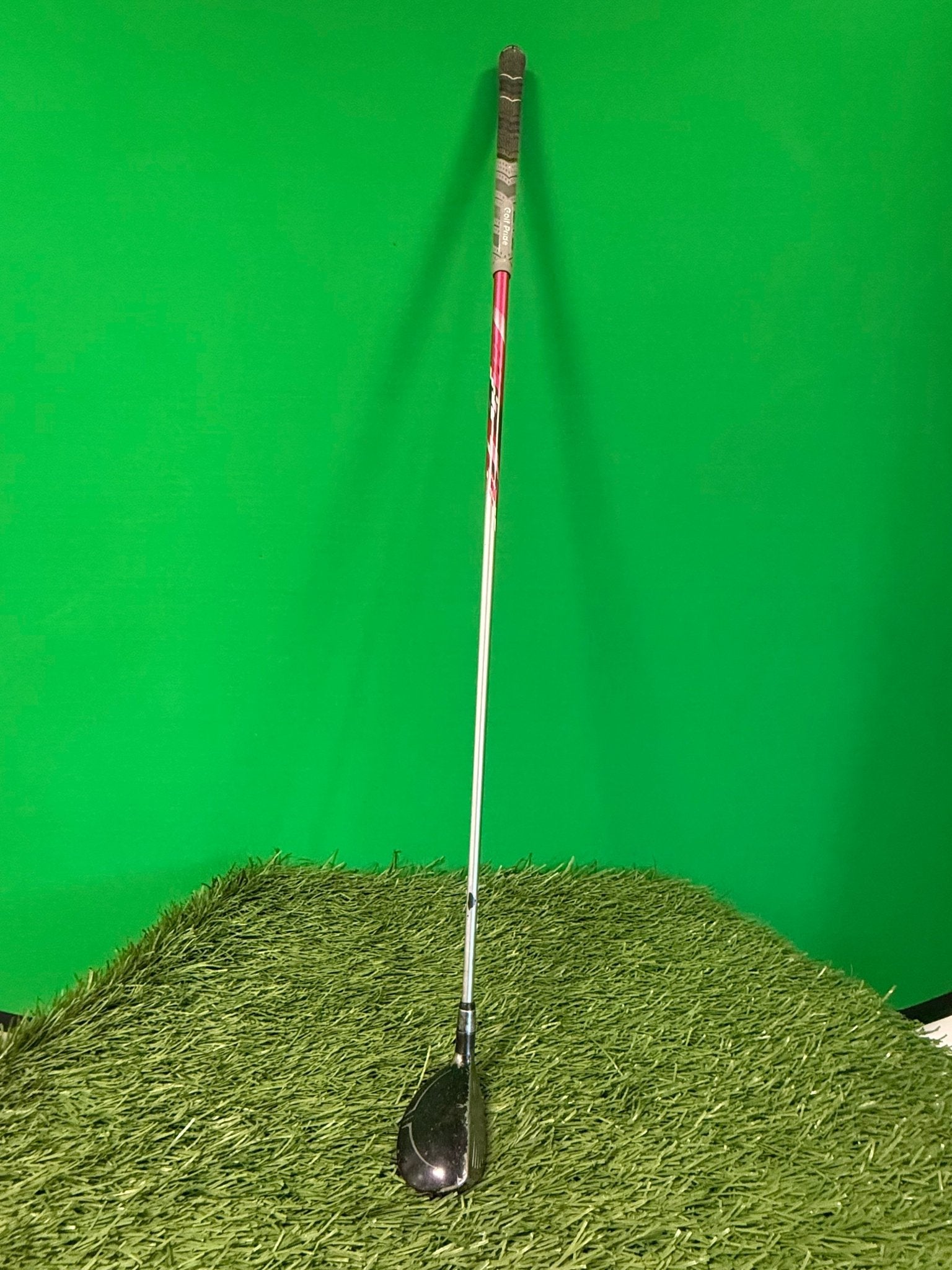 Yonex rescue Hybrid golf club standing on artificial grass