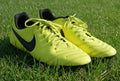 Pair of yellow Nike Tiempo football boots on grass